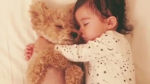 Cute baby sleeping with his puppy
