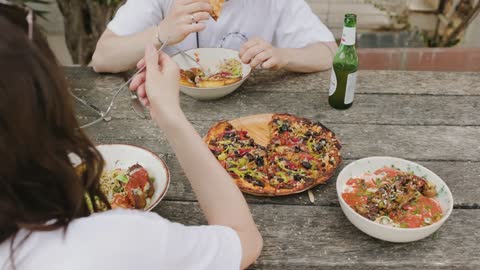 people-eating-salad-and-pizza pizza