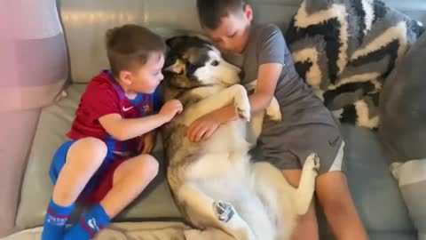 These two boys have a special bond with his puppy Husky best friend