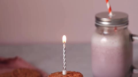 A Person Lighting a Candle on Top of the Cookie Sandwich