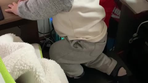 Baby climbing on the computer