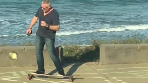 Commentary of dad grey white hair on phone riding by on longboard