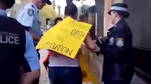 A mother protesting against Covid-19 lockdown in Australia is arrested in front of her crying child