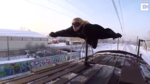 Bat girl riding on the roof of trains