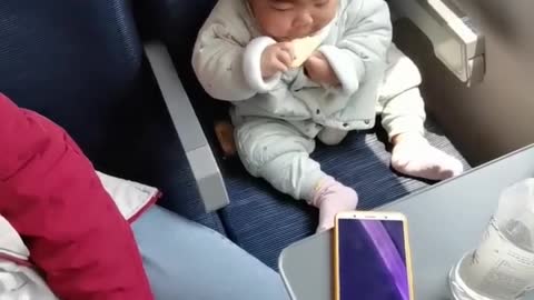 Cute baby eating in funny way