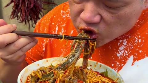 Cook And Eat Spicy Noodles With Fried Eel