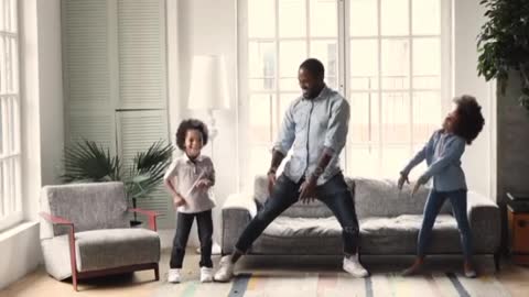 African dad dancing having fun with kids in living room ❤️