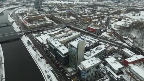 Slow Landing Over Houses Near River In City, Winter