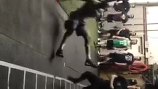 Guy wearing cleats slips on floor during football practice
