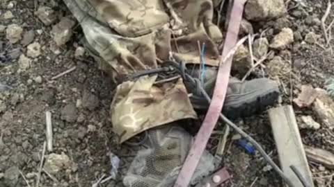 Ukrainian war [2022]. Dead Russian POW has tied legs and pierced hands.