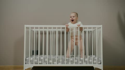 A Baby Jumping and Smiling