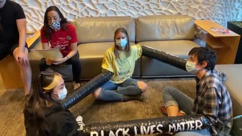 BLM Protesters Occupy Ted Wheeler's Apartment And Tie Their Arms Together Demanding His Resignation