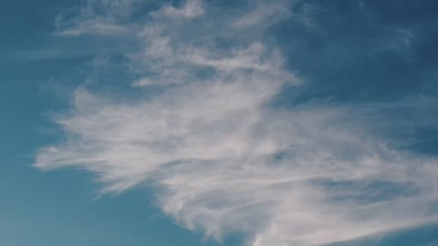 Blue sky with moving clouds