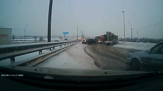 Jackknifing Truck Slides Through Traffic on Icy Road