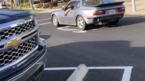 Guy drives by with two surfboards hanging outside his sunroof