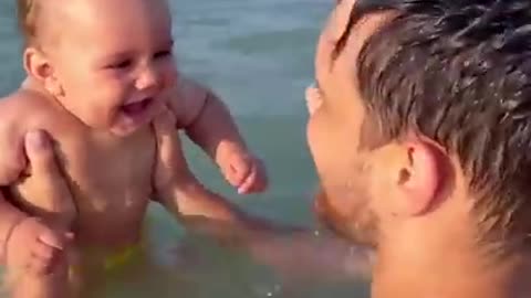 Billy baby laughing on the beach