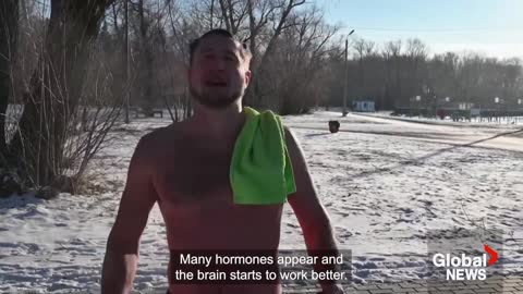 Siberian enthusiasts plunge into ice-cold river to kick off winter swimming season