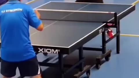 man flings his ping pong bat into opponents head on the serve.