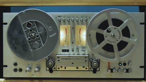 Retro audio tape recorder in motion