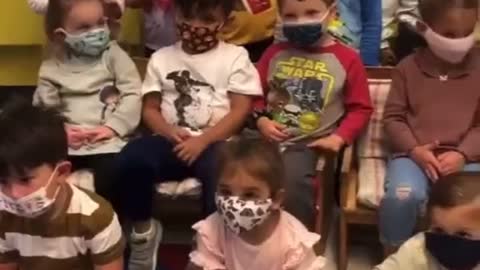 Teacher Singing A Mask Song With Young Children