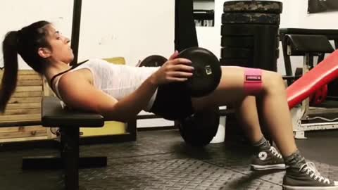 Beautiful woman exercises her waist in the gym to make her waist more beautiful.