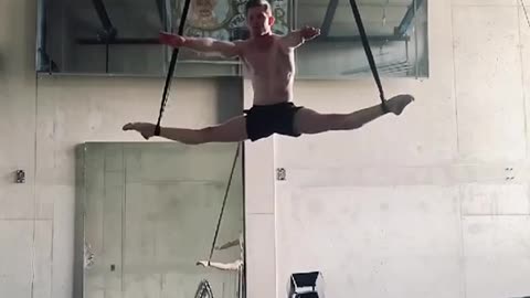 Acrobat Displays Incredible Strength And Flexibility While Training on Aerial Straps