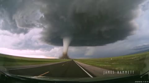 Storm chasing dashcam: Tornado crossing the highway! Laramie, Wyoming