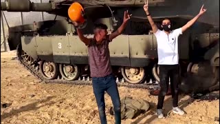 Palestinians celebrate near purported Israeli tank