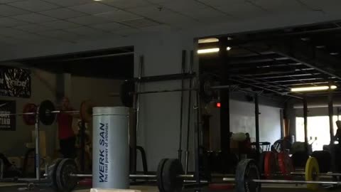 A woman in green was lifting weights