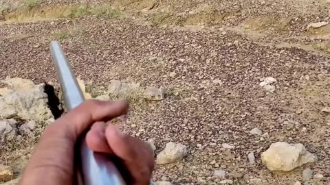 Shooting bottle in air by short gun