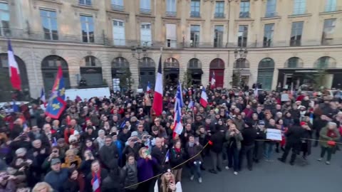 NATO flag is cut during rally of "thousands" of people in Paris
