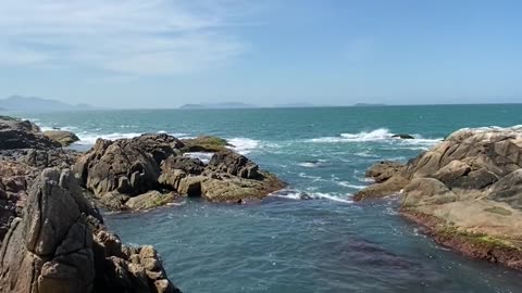 rocks on sea shore under clear view