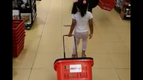 Toddler doing grocery shopping