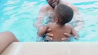 BABY LEARNING SWIMMING