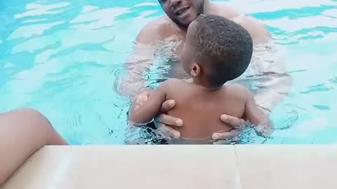 BABY LEARNING SWIMMING