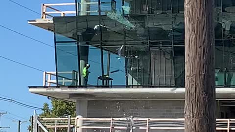 Construction Workers Break Large Glass Window