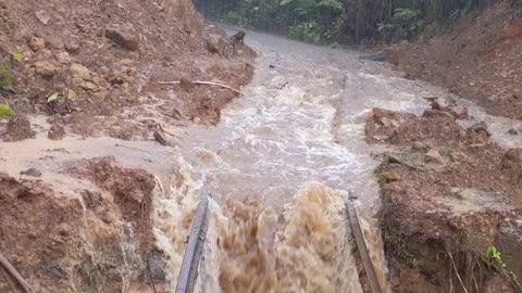 Train Crosses Risky Rails in the Rain