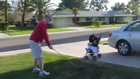 Baby laughs at golf swing