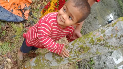 Cute Baby Playing in the River Port of Bangladesh