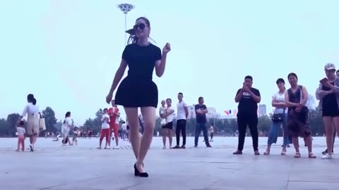 A girl dancing in heels in the center of the city...