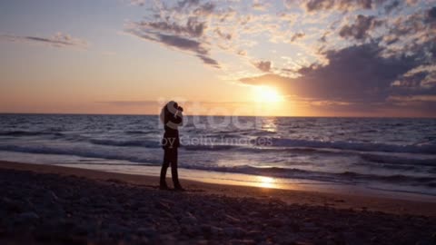 Photographer On Beach At Sunset stock video