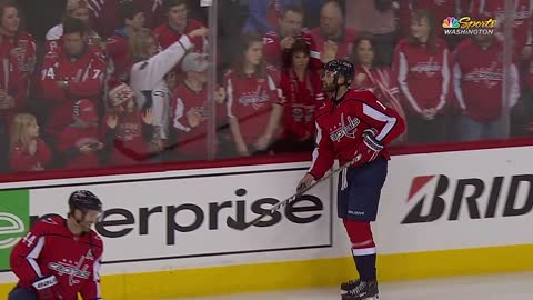 Brett Connolly hands the puck to a happy little girl (Ice Hockey).