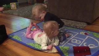 Priceless baby twins kissing and playing
