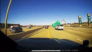 Strong Winds Blow Freeway Sign onto the Road