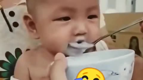 Cute Baby - the baby is drinking with a spoon and laughing