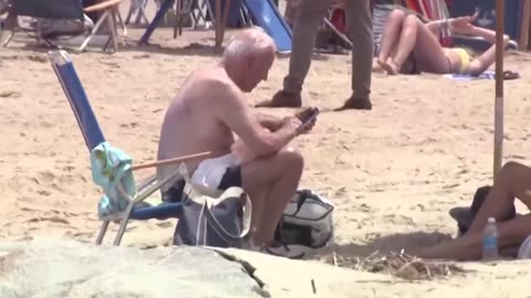 A shirtless Joe Biden enjoys the beach on his 353th day of vacation