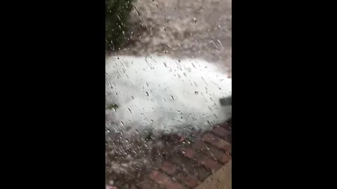 Hailstones Spill Out From Gutters and Pile Up on Ground During Massive Hailstorm