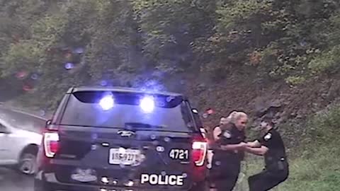 Video captured the moment an officer pulled his colleague away from an oncoming car