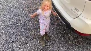 Little Girl Holds on to Opening Trunk