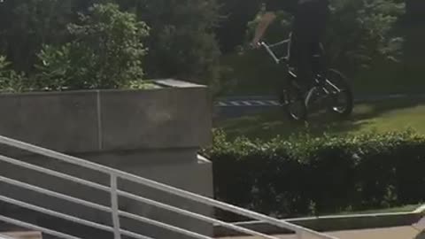 White helmet slowmo bicycle grinds concrete barrier bike breaks